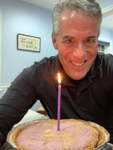 person smiling with birthday cake