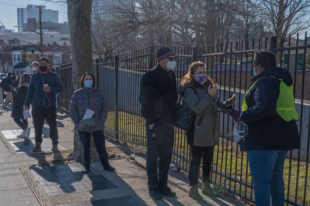 Vaccine line People who are eligible and registered wait in line to get COVID-19 vaccine at NYC Health Department Vaccine Hub at Hillcrest High School in Queens.