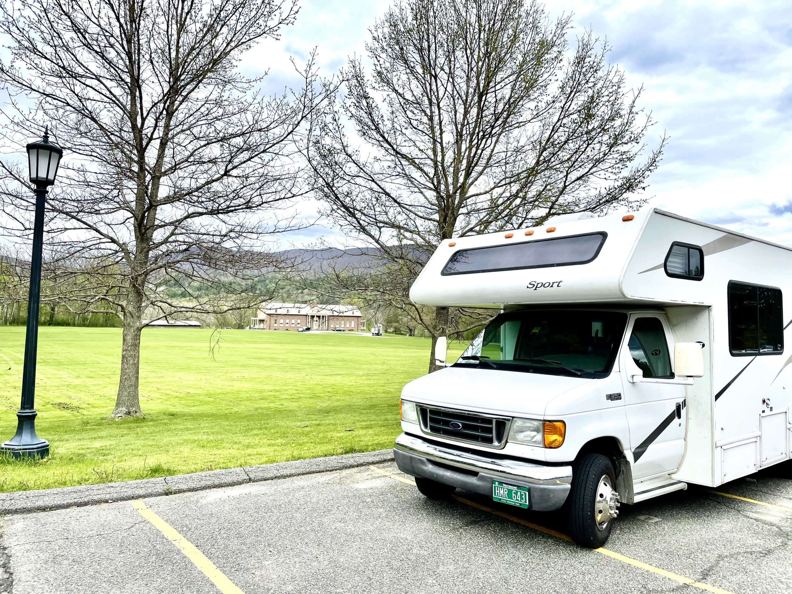 IMG_6535 photo of an RV parked next to a field with a lamp post on the left