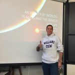 Person standing with Thumbs Up in front of Lecture Screen