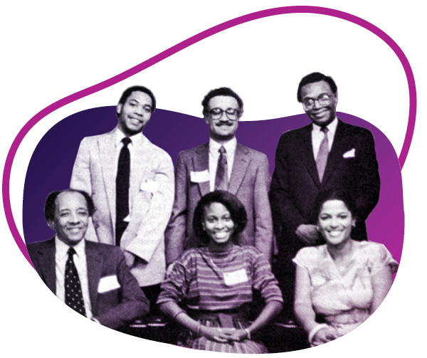group of people, with three seated and three standing behind smiling and posing