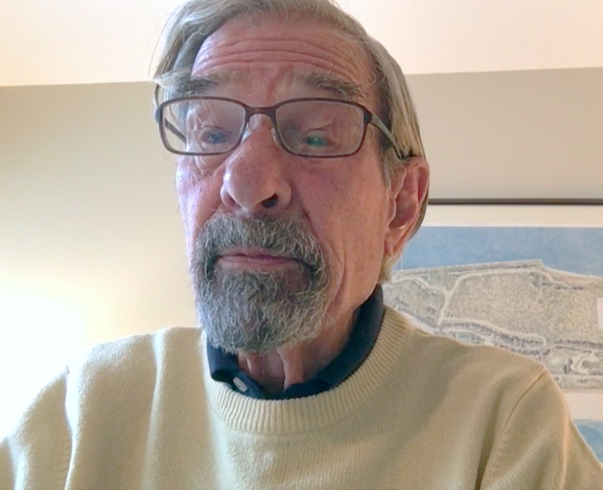 man wearing glasses and yellow sweater