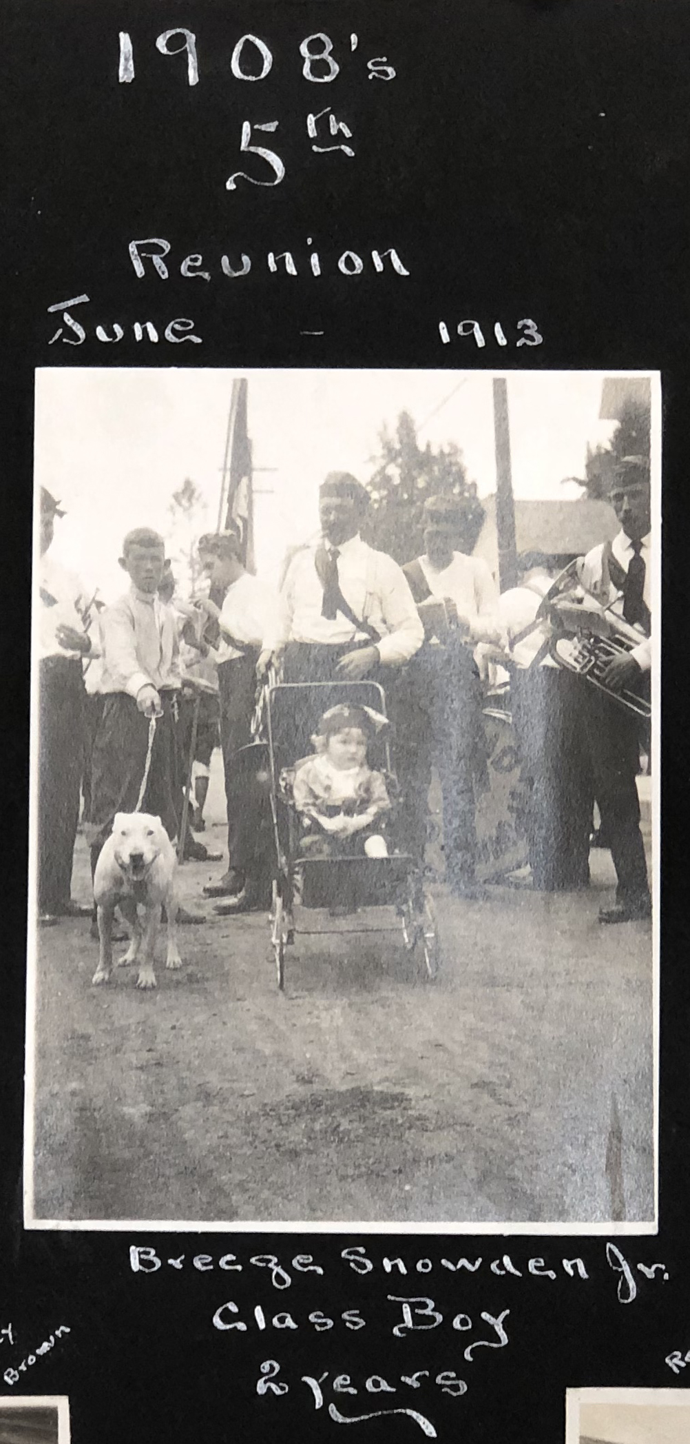 e kendall gillett scrapbook 10 A black and white photography in an album shows a young boy in a stroller with the class of 1908 at their five-year reunion.