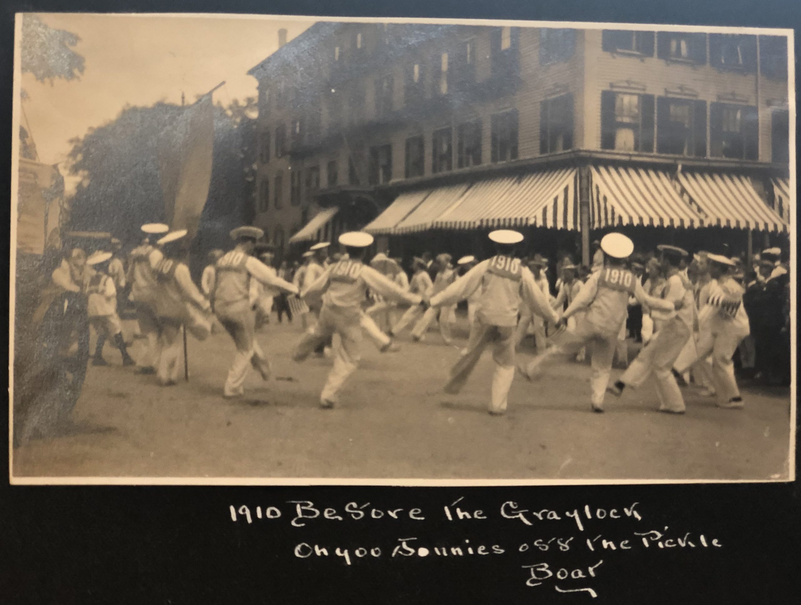 e kendall gillett scrapbook 15 A black and white photograph in an album shows men from the class of 1910 dressed as sailors with dancing in the street at their three-year reunion.