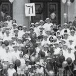 B&W photo of people gathered toegther