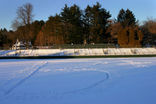 Photograph of Amherst football field covered in snow with B+ stomped into snow
