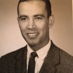 Black and White photo of man in suit and tie from chest up