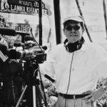 Black and white photo of Michael Rosenblum in front of video camera