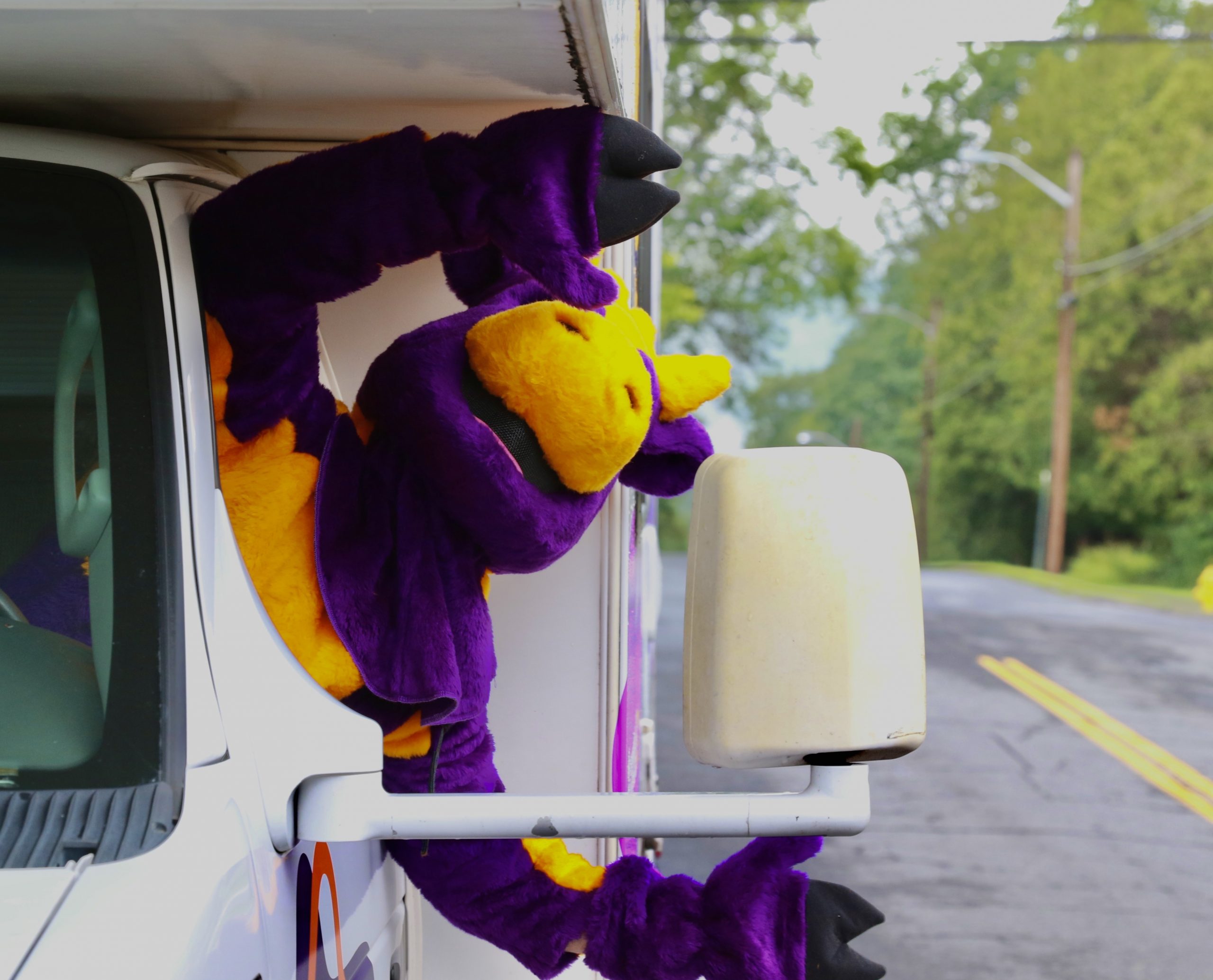 Ephelia looking out from the RV and waving hands out