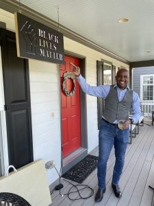 Tamaan points to his Black Lives Matter sign in his porch.