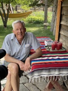 a person sitting down outdoors at a picnic table