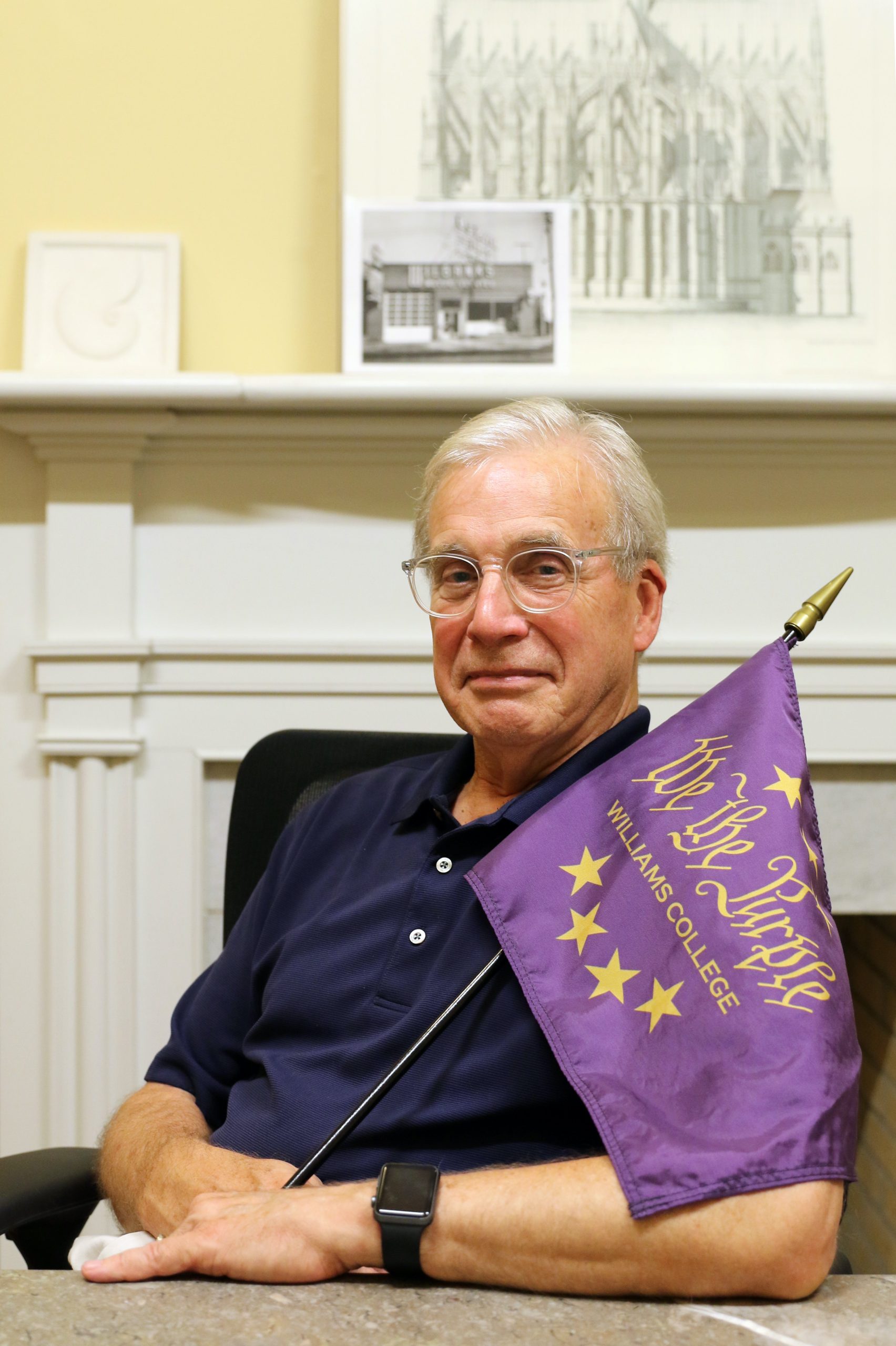 a man holding a purple flag while sitting down