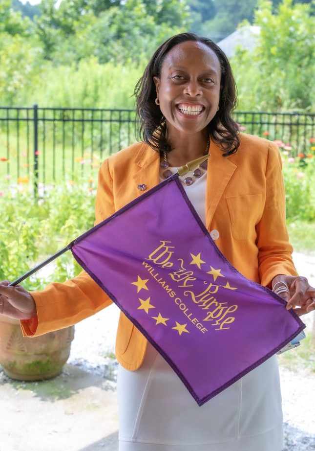 Cassandra holds the 'We the Purple' flag.